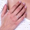 Diamond_solitaire_split_shank_engagement_ring_on_hand