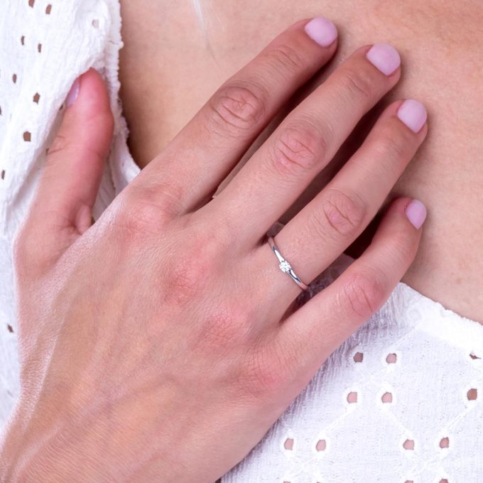 Diamond_solitaire_split_shank_engagement_ring_on_hand