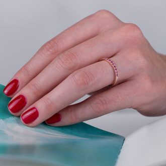 Thin_pink_sapphire_half_eternity_ring_on_hand