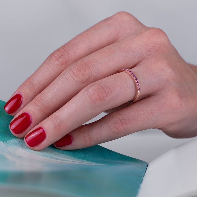 Thin_pink_sapphire_half_eternity_ring_on_hand