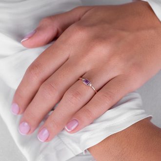Pink_sapphire_baguette_and_diamond_engagement_ring_on_hand