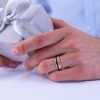 Brushed_Carbon_wedding_ring_with_black_diamonds_on_hand