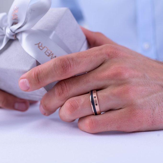 Brushed_Carbon_wedding_ring_with_black_diamonds_on_hand