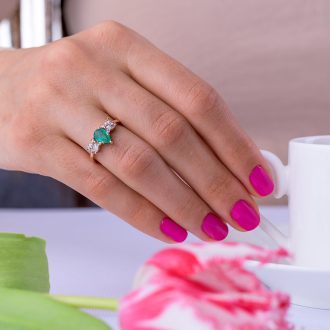 Pear_Emerald_and_diamond_cluster_engagement_ring_on_hand