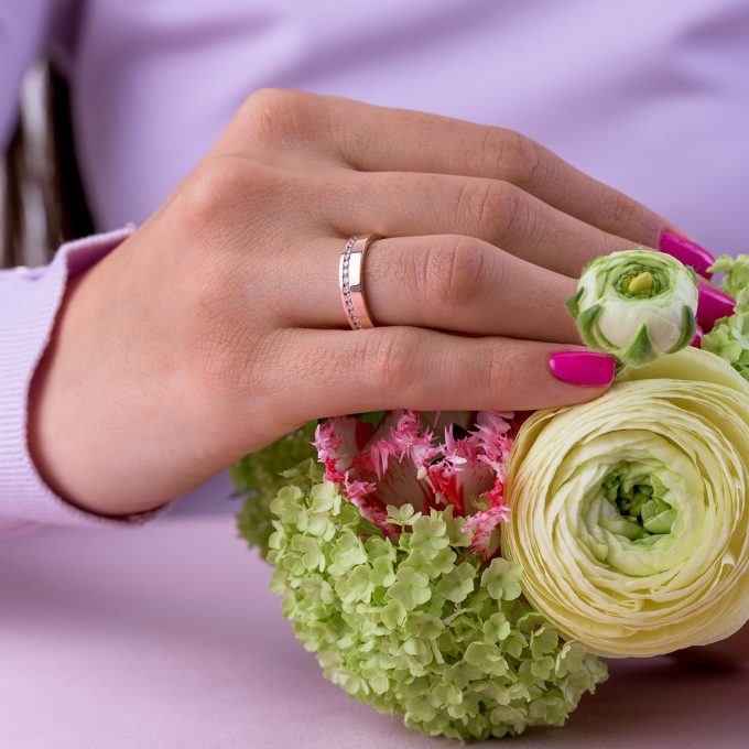 Half_eternity_channel_setting_wide_wedding_ring_on_hand