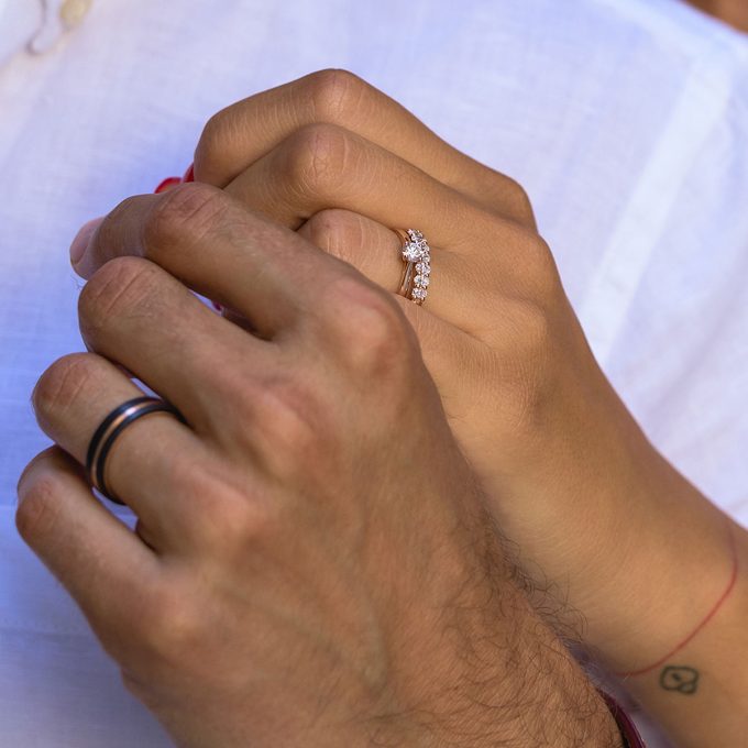 Half_eternity_wedding_ring_with_oval_diamonds_on_hand
