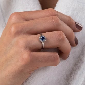Sapphire_Diamond_halo_engagement_ring_on_hand