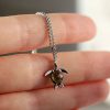 Edinstvena_ogrlica_speca_morska_zelva_s_safirjem_in_diamanti_na_roki One_of_a_kind_sleeping_sea_turtle_sapphire_and_diamond_necklace_on_Hand