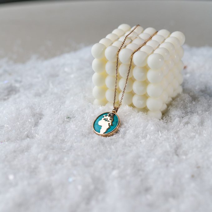 One_of_a_kind_turquoise_world_map_necklace_on_cube